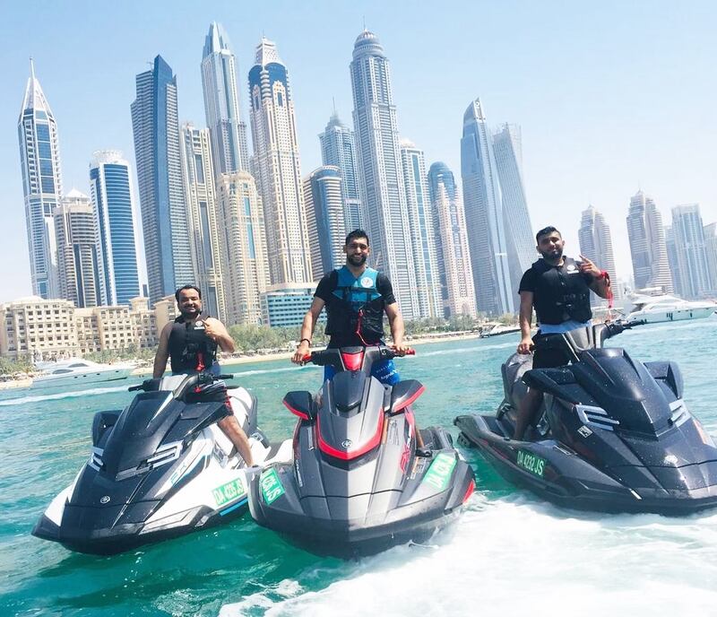 Amir Khan jet skis with friends Pablo and Waseem with a Dubai Marina backdrop. Instagram / Amir Khan 