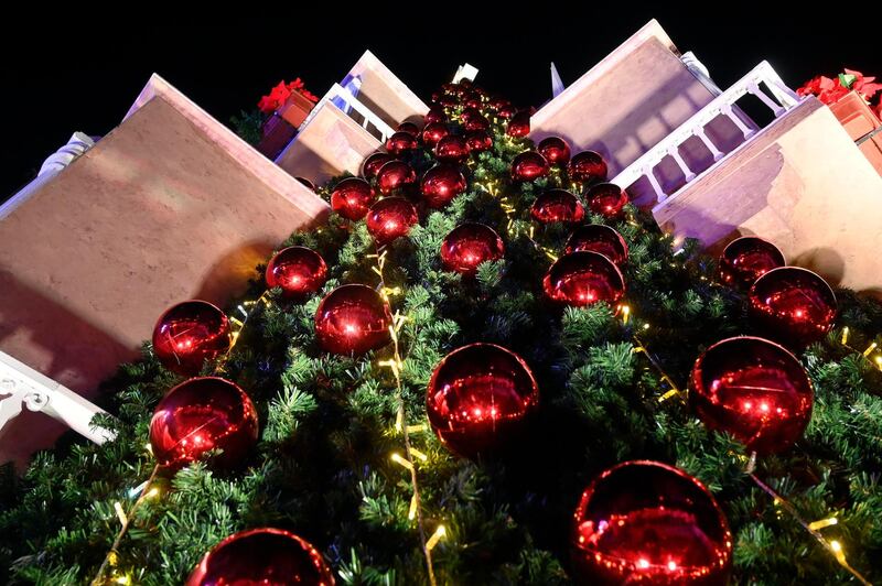 Lebanese people gather next to a giant Christmas tree which has been officially lit up at the Ashrafieh area in Beirut. EPA