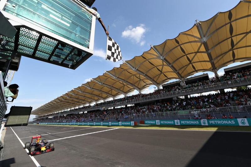 Daniel Ricciardo, driving the (3) Red Bull Racing car, crosses the line to take the chequered flag. Mark Thompson / Getty Images