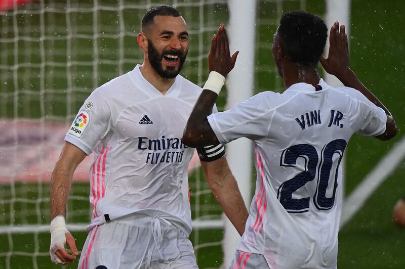 Real Madrid's Karim Benzema celebrates with Vinicius Junior after scoring. AFP