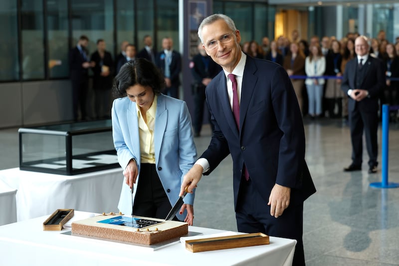 Nato Secretary General Jens Stoltenberg, right, and Belgium's Foreign Minister Hadja Lahbib cut a cake during a ceremony to mark the 75th anniversary of Nato at Nato headquarters in Brussels, Belgium. AP