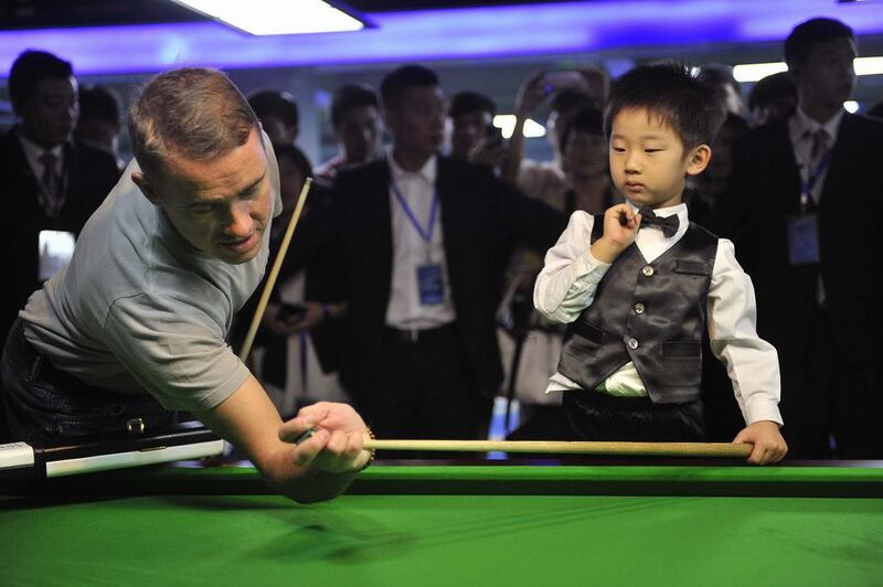Hendry, 41 years his senior, has a bit of fun playing against Wuka, and while he is at it, passes along a few handy tips. An experience of a lifetime, surely. Reuters