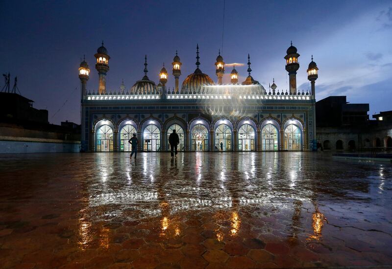 Muslim worshipers arrive for evening prayers after breaking their fast on the first day of Ramadan, in Rawalpindi, Pakistan. AP