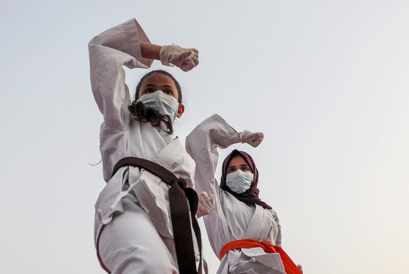 The daughters of Palestinian Karate coach Khaled Sheikh el Eid (not pictured) train together on the rooftop of their family house at a refugee camp in Rafah, in the southern Gaza Strip.  EPA