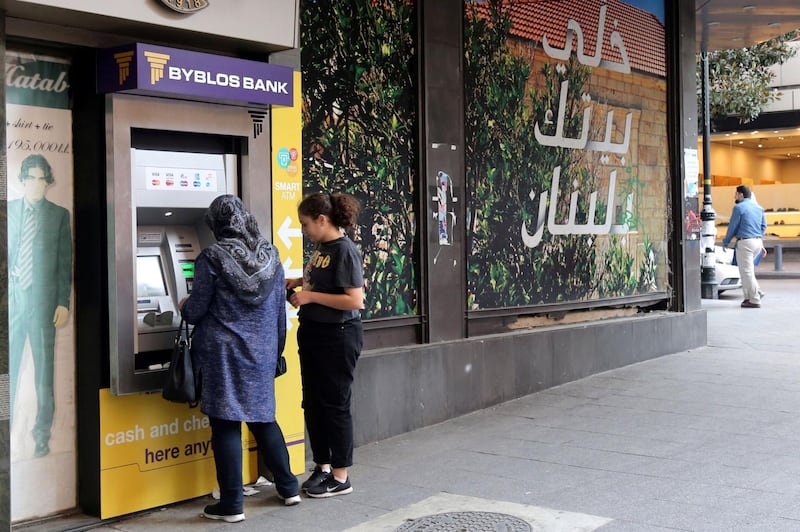 A woman withdraws money from a Byblos Bank ATM in Beirut.October 30, 2019. Hasan Shaaban/Bloomberg