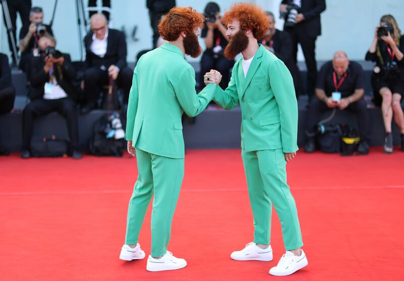 Italian brothers Fabrizio and Valerio Salvatori wear matching green double-breasted suits to the 'Il Signore Delle Formiche' screening. Getty