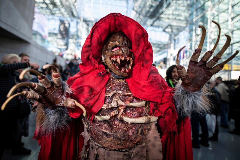 An attendee dressed as the monster from 'The Village' poses during New York Comic Con at the Jacob K.Javits Convention Center in New York.  AP