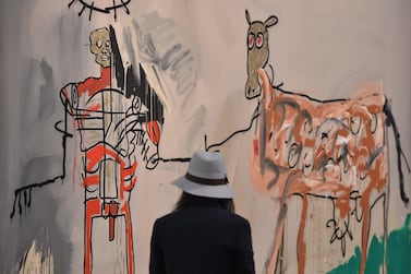 A woman visits the exhibition "Jean-Michel Basquiat", a retrospective on Jean-Michel Basquiat’s career from graffiti in New York to more complex work. AFP
