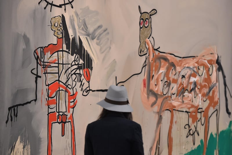 A woman visits the exhibition "Jean-Michel Basquiat", a retrospective on Jean-Michel Basquiat’s career from graffiti in New York to more complex work. AFP