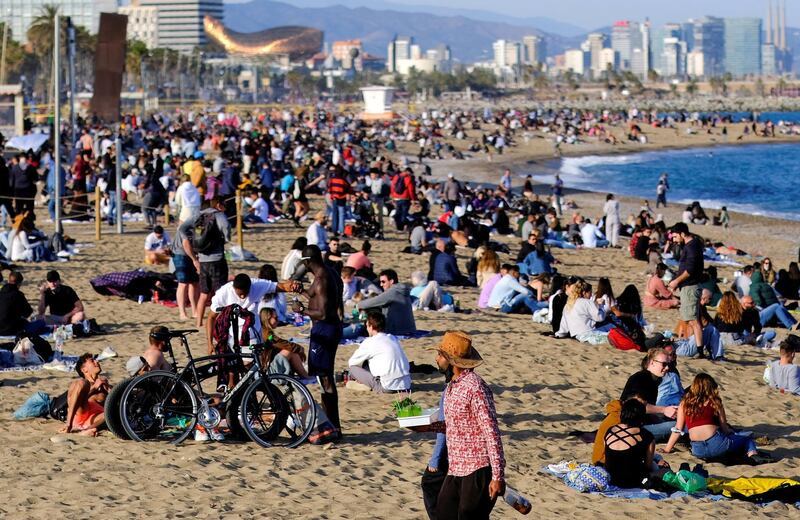 FILE PHOTO: People spend time at Barceloneta beach, amid the coronavirus disease (COVID-19) outbreak, in Barcelona, Spain April 2, 2021. REUTERS/Nacho Doce/File Photo