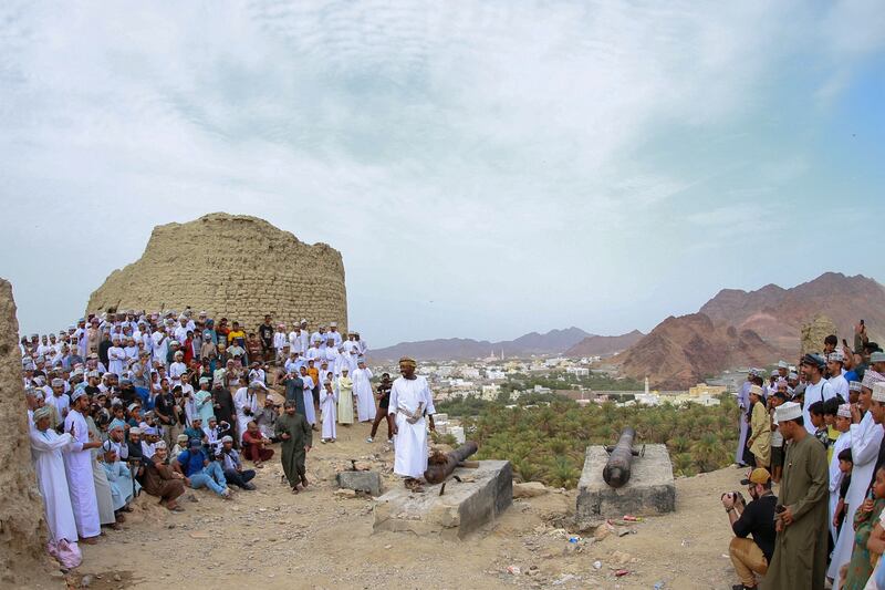 An Omani man prepares to fire cannons in celebration of Eid Al- Adha, in Fanja.