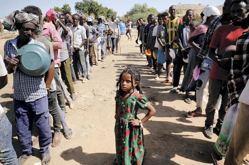 Ethiopian refugees wait in lines for a meal at the Um Rakuba refugee camp which houses Ethiopian refugees fleeing the fighting in the Tigray region, on the Sudan-Ethiopia border, Sudan, November 28, 2020. REUTERS/Baz Ratner