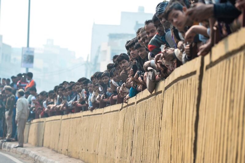 Onlookers gather along a fly over road following a factory fire in Anaj Mandi area of New Delhi. At least 43 people have died in a factory fire in India's capital New Delhi, with the toll still expected to rise.  AFP