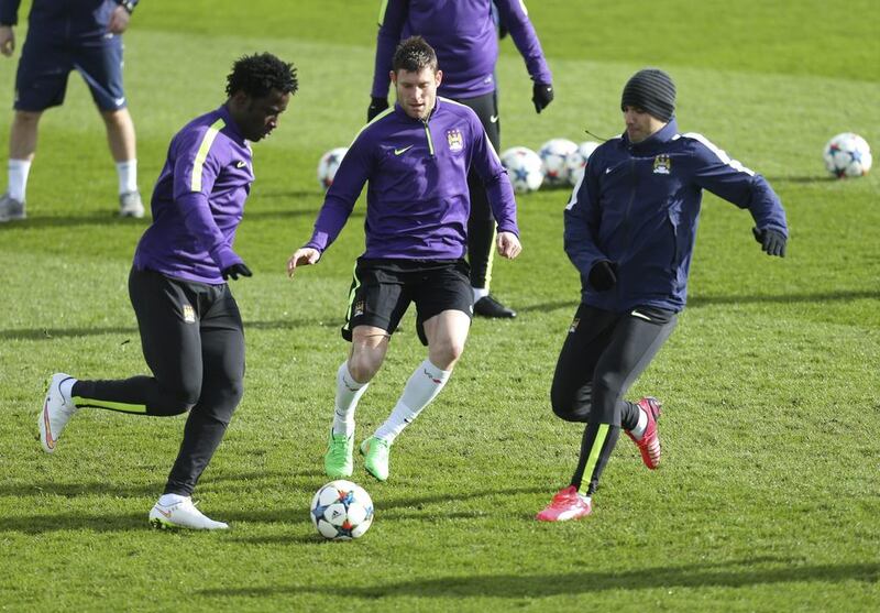 Wilfried Bony Kicks around the ball with James Milner and Sergio Aguero on Monday during Manchester City's Champions League training session. Carl Recine / Reuters