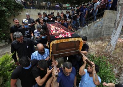 Relatives of Aya Hachem, a 19-year-old student who was killed in a shooting in Blackburn, Britain, on Sunday, carry her coffin during the funeral at a cemetery in her family's hometown of Qlaileh, near Tyre, southern Lebanon May 23, 2020. REUTERS/Aziz Taher