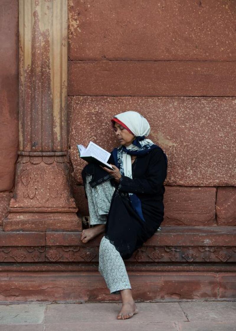 An Indian Muslim devotee reads from the Quran in the courtyard of the Jama Masjid during the Islamic holy month of Ramadan on July 6, 2014. Sajjad Hussain/AFP Photo
