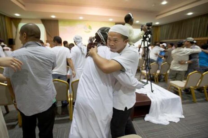 Dubai, United Arab Emirates, Aug 30, 2013 - People hugging each other during the speach of Ahmed Hamed at the One day Seminar for people new to Islam New Muslim Retreat at the Auditotium Dar Al Ber Society. ( Jaime Puebla / The National Newspaper ) Ramola