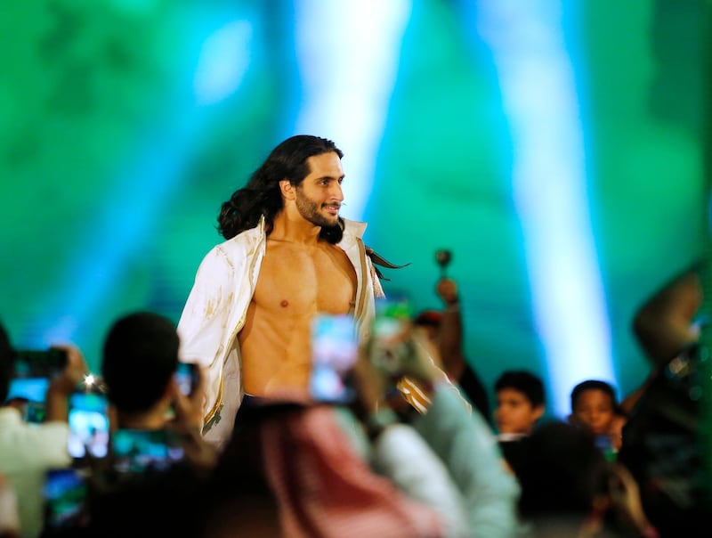 Fans film Saudi wrestler Mansoor as he makes his entrance. AP Photo