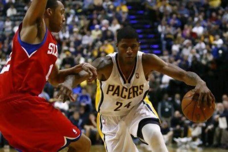 Indiana Pacers guard Paul George drives past a Philadelphia 76ers player on Saturday.