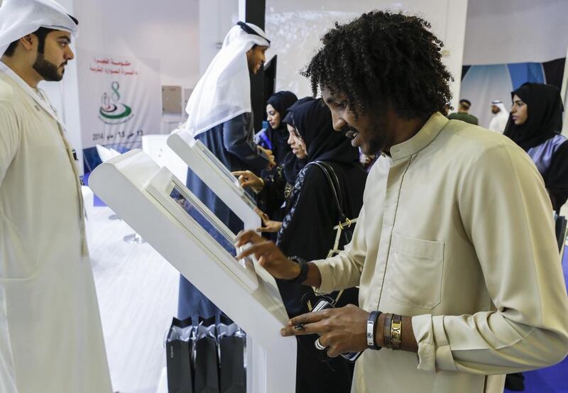 Saeed Khames, 21, a student from Fujairah, fills in an application to be considered for employment at the Bank of Fujairah. Antonie Robertson / The National