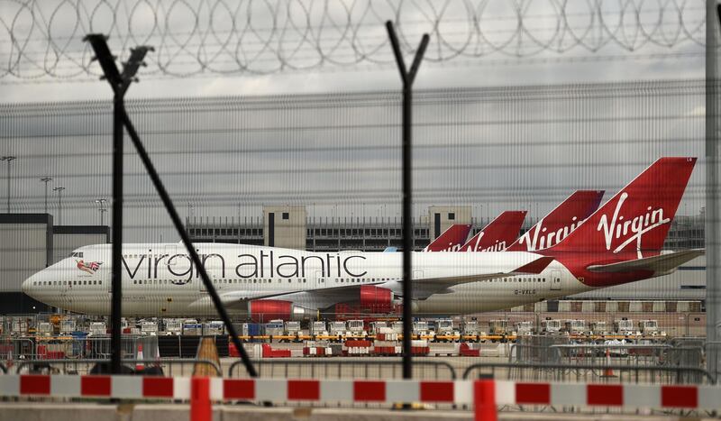 Virgin Atlantic Airline planes are pictured at the apron at Manchester Airport in north-west England, on June 8, 2020, as the UK government's planned 14-day quarantine for international arrivals to limit the spread of the novel coronavirus begins.  / AFP / Oli SCARFF                          
