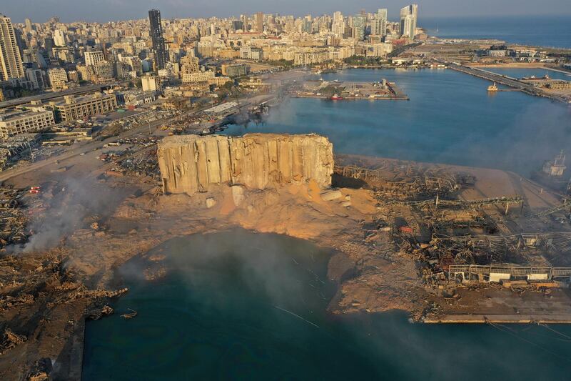 A drone picture shows the scene of an explosion that hit the seaport of Beirut, Lebanon, Wednesday, Aug. 5, 2020. A massive explosion rocked Beirut on Tuesday, flattening much of the city's port, damaging buildings across the capital and sending a giant mushroom cloud into the sky. (AP Photo/Hussein Malla)