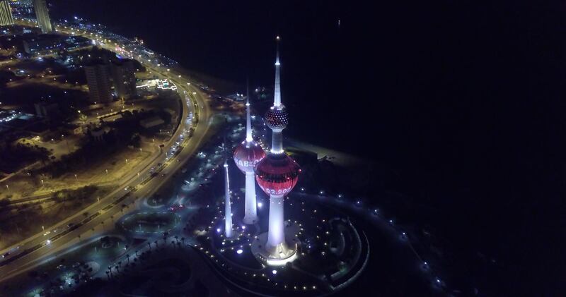 Kuwait landmark lit in red.