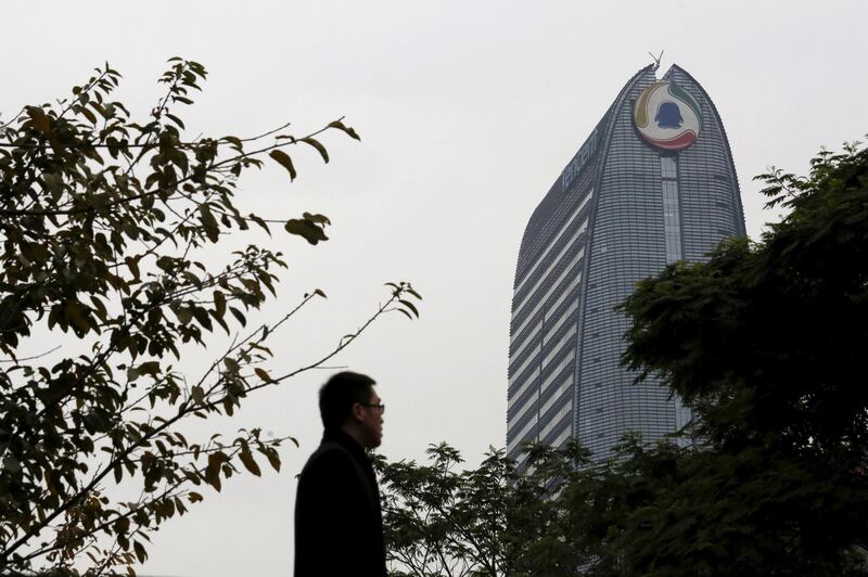FILE PHOTO: A man walks in front of Tencent headquarters in Shenzhen, China March 15, 2016, before the company announces its annual results on March 17, 2016.    REUTERS/Bobby Yip/File Photo