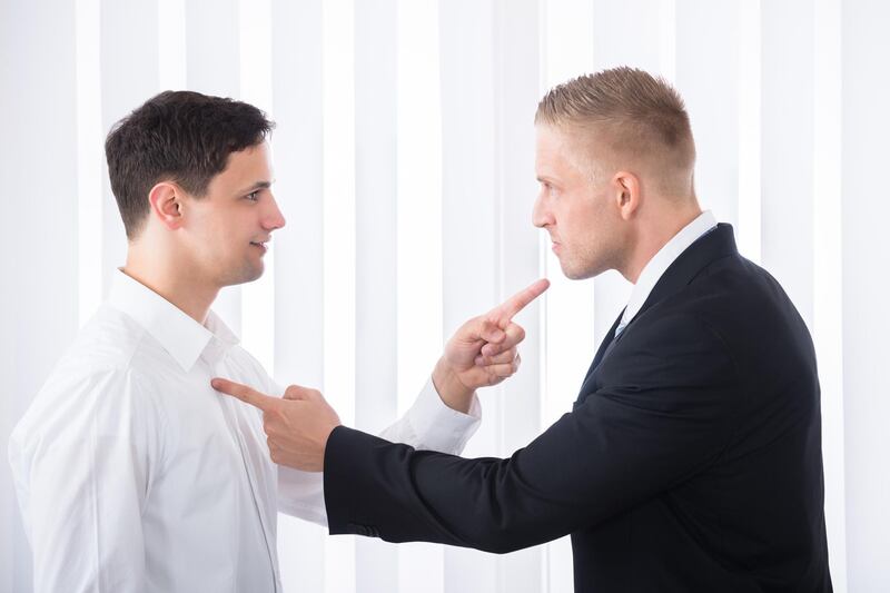 K5KR42 Portrait Of Two Young Businessmen Pointing Finger At Each Other