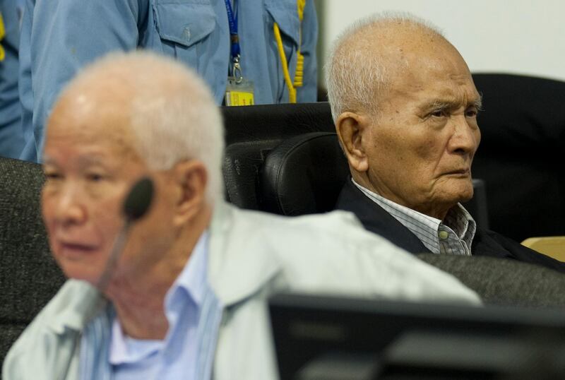 FILE - In this Oct. 31, 2013, file photo released by the Extraordinary Chambers in the Courts of Cambodia, Khieu Samphan, left, former Khmer Rouge head of state, and Nuon Chea, right, who was the Khmer Rouge's chief ideologist and No. 2 leader, sit in the court hall at the U.N.-backed war crimes tribunal in Phnom Penh, Cambodia. The U.N.-assisted international tribunal in Cambodia judging former leaders of the Khmer Rouge for their roles in abuses that led to the deaths of an estimated 1.7 million of their countrymen will issue verdicts Friday, Nov. 16, 2018,  in the latest - and perhaps last - of such trials.  Nuon Chea, 92, and Khieu Samphan, 87, are the last two surviving senior leaders of the radical communist group that brutally ruled Cambodia in the late 1970s. (Mark Peters/Extraordinary Chambers in the Courts of Cambodia via AP, File)