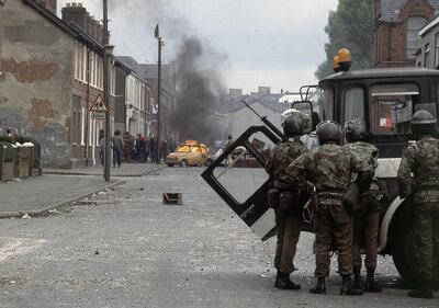 FILE - In this May 5, 1981 file photo British troops, in foreground, clash with demonstrators in a Catholic dominated area of Belfast, Northern Ireland. The chaotic scenes during a week of violence on the streets of Northern Ireland have stirred memories of decades of Catholic-Protestant conflict, known as "The Troubles." A 1998 peace deal ended large-scale violence but did not resolve Northern Ireland's deep-rooted tensions. (AP Photo, File)