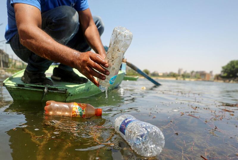 Saad Hassanein, a 46-year-old fisherman, collects discarded plastic bottles from the Nile river in Giza, Egypt. Reuters