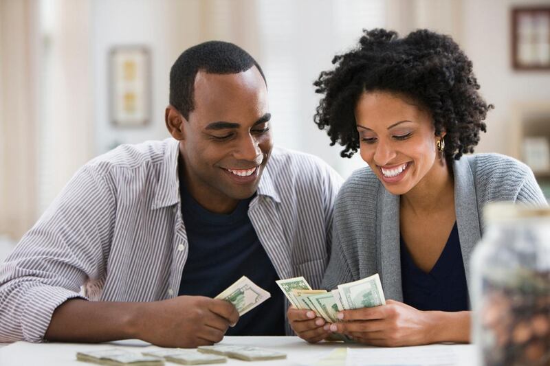 A couple counting money. Universal basic income lets people bridge periods out of work or in bad jobs so they can invest in their own skills and re-enter the workforce at a higher level. Getty Images