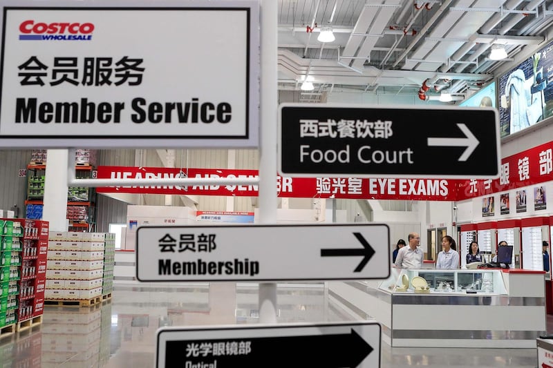 This photo taken on August 20, 2019 shows signs at a Costco store during a media day in Shanghai ahead of its official opening on August 27. The US retail giant Costco is diving into the thorny area of food retail in China with its first store opening on August 27, but analysts warn it faces a tough ride as it looks to succeed where a series of international retailers have failed. - China OUT
 / AFP / STR

