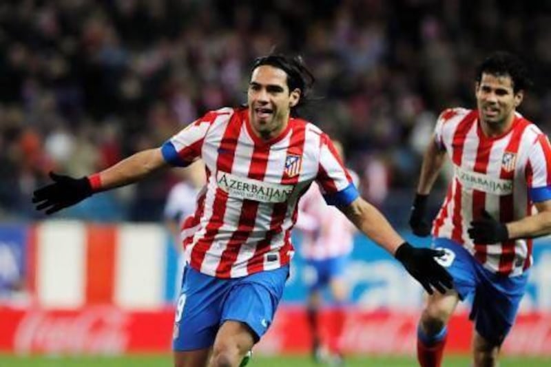 CAPTION CORRECTION, CORRECTS NAME OF OPPOSING TEAM AND OF STADIUM - Atletico de Madrid's Radamel Falcao from Colombia, left, celebrates his goal with Diego Costa from Brazil, right, during a Spanish La Liga soccer match against Deportivo la Coruna at Vicente Calderon Stadium in Madrid, Spain, Sunday, Dec. 9, 2012. (AP Photo/Andres Kudacki) *** Local Caption *** CORRECTION Spain Soccer La Liga.JPEG-07406.jpg