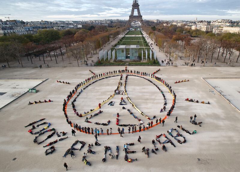 Climate activists form a human chain spelling out '100% renewable', at Cop21 in Paris in 2015. AP