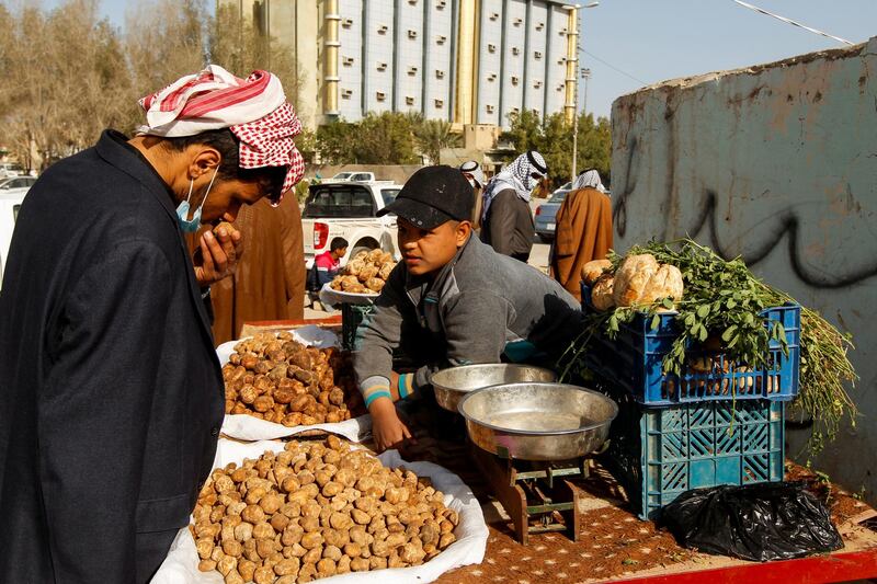 A man buys truffles at a market in the city of Samawa, Iraq. Reuters