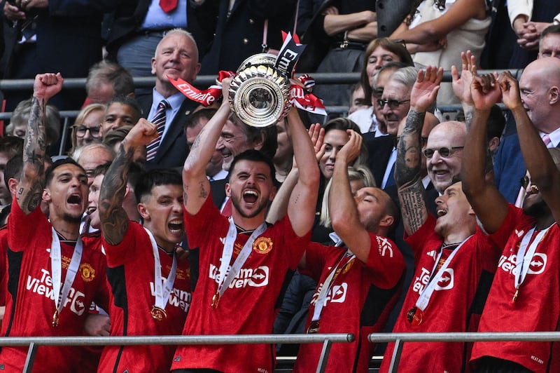 Manchester United's English midfielder #07 Mason Mount lifts the trophy to celebrate their victory at the end of the English FA Cup final football match between Manchester City and Manchester United at Wembley stadium, in London, on May 25, 2024.  Manchester United wins 2 - 1 against Manchester City.  (Photo by JUSTIN TALLIS  /  AFP)  /  NOT FOR MARKETING OR ADVERTISING USE  /  RESTRICTED TO EDITORIAL USE