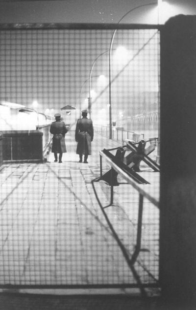 Two East German border guards walking away after closing gate at Oberbaumbrucke check point in the Berlin wall ending 14 day visitation period for West Berliners to visit East Berlin.  (Photo by Robert Lackenbach/The LIFE Images Collection/Getty Images)