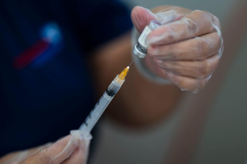 A healthcare worker prepares a dose of the Johnson & Johnson Covid-19 vaccine at the Ultimo Trolley public beach in San Juan, Puerto Rico. AP Photo