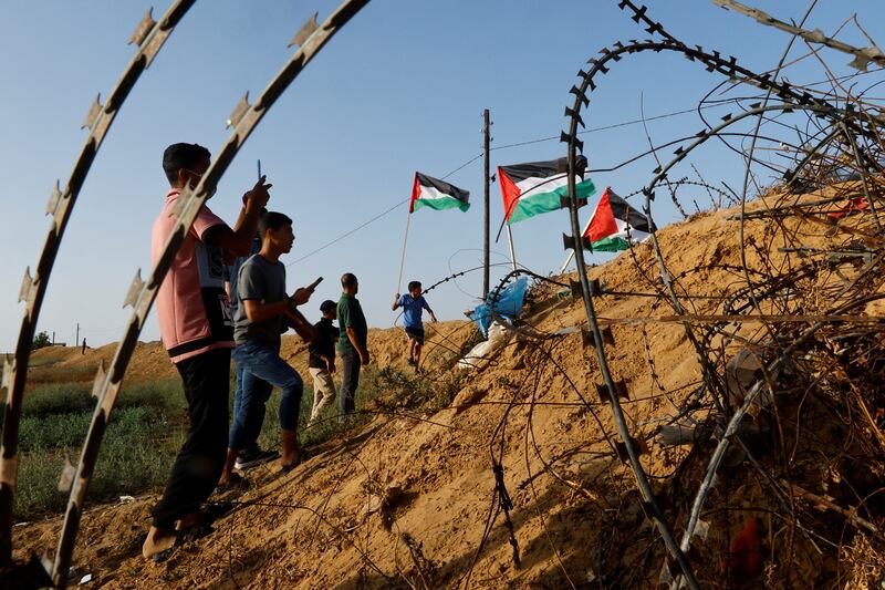 Palestinians protest along the Israel-Gaza border fence in Khan Younis, in the southern Gaza Strip, against the Israeli army raid in Jenin. Reuters