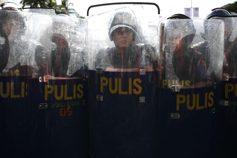 Philippine riot policemen stand guard during a protest against US president Donald Trump outside the Philippine International Convention Center, venue of the upcoming 31st Association of Southeast Asian Nations (ASEAN) Summit in Manila. MANAN VATSYAYANA / AFP