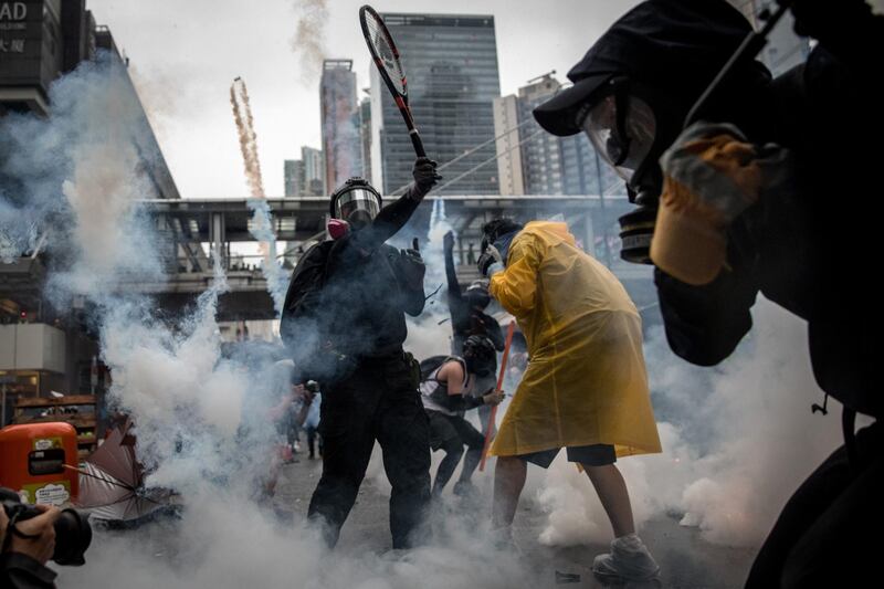 ***BESTPIX*** HONG KONG - AUGUST 25: A protester uses a tennis racquet to hit back tear gas canisters during clashes with police after an anti-government rally in Tsuen Wan district on August 25, 2019 in Hong Kong, China. Pro-democracy protesters have continued rallies on the streets of Hong Kong against a controversial extradition bill since 9 June as the city plunged into crisis after waves of demonstrations and several violent clashes. Hong Kong's Chief Executive Carrie Lam apologized for introducing the bill and declared it "dead", however protesters have continued to draw large crowds with demands for Lam's resignation and complete withdrawal of the bill. (Photo by Chris McGrath/Getty Images)