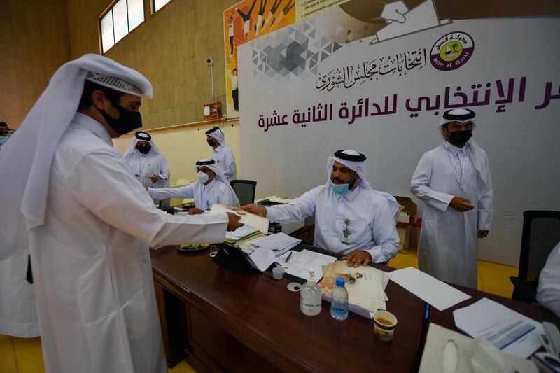 A Qatari man receives his ballot paper in Doha. Reuters