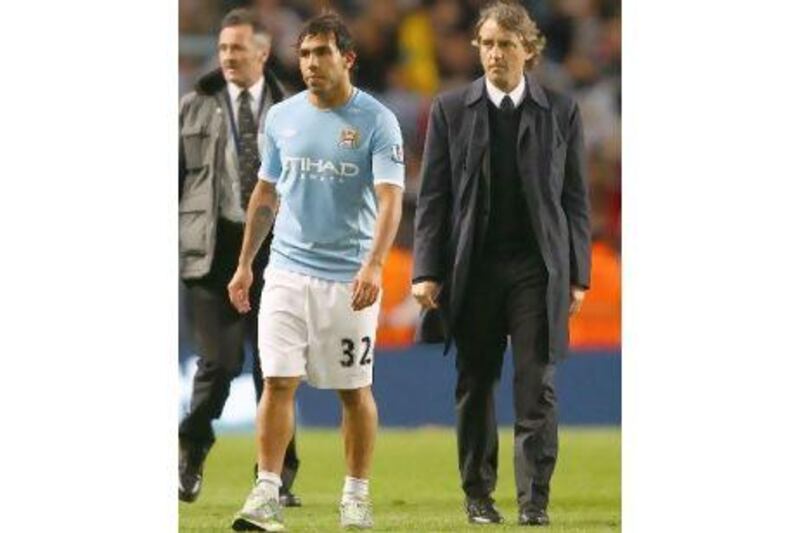 Roberto Mancini, the Manchester City manager, right, and captain Carlos Tevez.