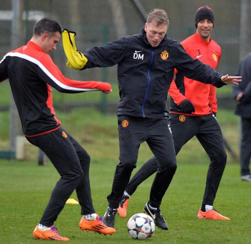 David Moyes with Robin van Persie, left, and Rio Ferdinand, right, on Tuesday. Paul Ellis / AFP / March 18, 2014