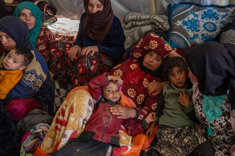 Women and children wait in a tent in Douzrou, Morocco, after losing their homes in Friday's earthquake. Getty Images