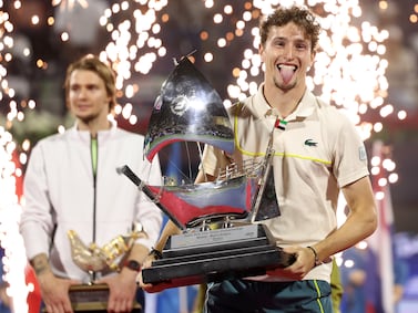 DUBAI, UNITED ARAB EMIRATES - MARCH 02: Ugo Humbert of France celebrates victory with the trophy over Alexander Bublik of Kazakhstan in the final match during the Dubai Duty Free Tennis Championships at Dubai Duty Free Tennis Stadium on March 02, 2024 in Dubai, United Arab Emirates. (Photo by Christopher Pike / Getty Images)
