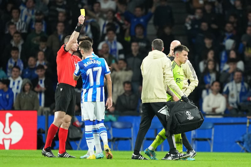 Referee Georgi Kabakov shows a yellow card to United defender Lisandro Martinez. Getty