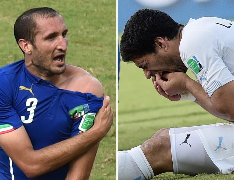 Uruguay striker Luis Suarez, right, has been suspended for nine official matches and banned from all football activity for four months by Fifa after biting Italy defender Giorgio Chiellini, let, during their 2014 World Cup Group D match at the Dunas Arena in Natal on June 24, 2014. Uruguay won the match 1-0. Yasuyoshi Chiba and Daniel Garcia / AFP
